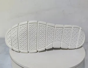 Detailed view of white lightweight loafers with anti-slip diamond grip pattern sole