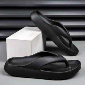 Close-up of black EVA platform flip-flops with anti-slip texture on geometric stand