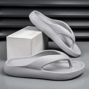 Detail view of thick-soled EVA flip flops in light gray with non-slip texture