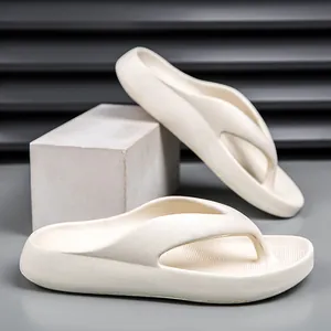 Detail view of thick-soled EVA flip flops in off-white finish on a geometric stand