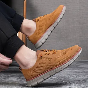 Detail showing brown fly-knit mesh texture and grey foam sole of casual men's loafers