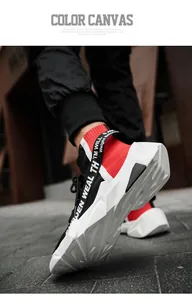 Low-angle view of red and black high-top knit sock sneakers with chunky white soles