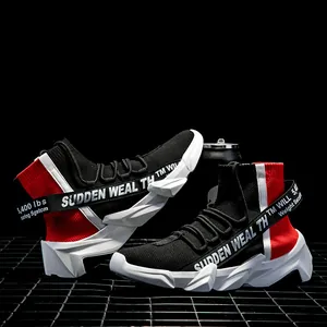 Detail of high-top sock sneakers featuring black knit fabric and bold white chunky sole