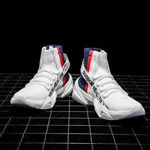 Macro shot of white high-top knit sneakers with red-blue straps on a black mesh background