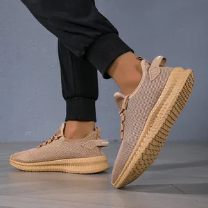 Close-up of khaki breathable mesh running shoes with anti-slip rubber soles on feet