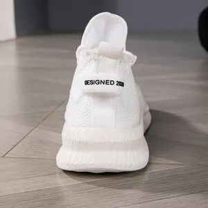 Close-up of white breathable knit running shoes with DESIGNED 2020 heel tab detail