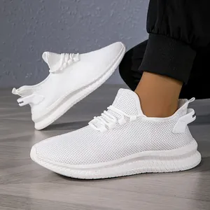 Detail of white mesh breathable running shoe featuring wave pattern outsole and heel pull tab