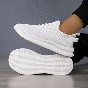 Detailed view of breathable white mesh sneakers with anti-slip rubber soles and laces