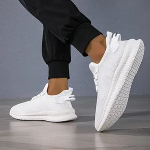 Detail view of white breathable mesh sneakers featuring a thick geometric anti-slip sole