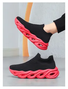 Detail showing breathable knitted upper and red hollowed cushioning sole on sneakers