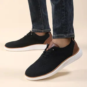 Detail view of black knit casual shoes with brown leather trim and thick white soles