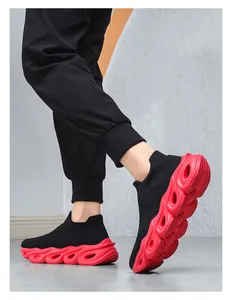 Side view of men's slip-on knit sneakers featuring a red hollow-out shock-absorbing sole