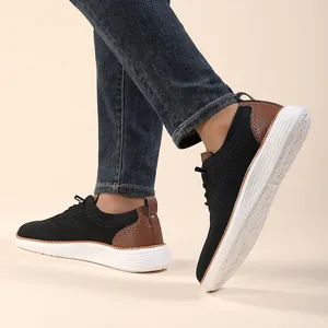 Detail of men's black knit sneakers with brown leather panels and brogue detailing