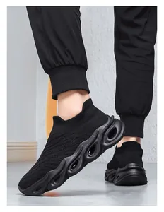 Detail of black breathable knit sneakers with futuristic hollowed-out wave sole