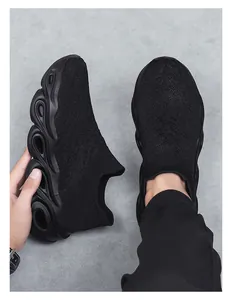 Close-up of black knitted slip-on sneaker featuring wave-patterned hollow out sole