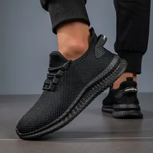 Close-up of black breathable mesh sneakers with chunky anti-slip soles and heel pull tab