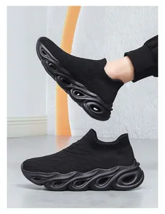 Detail of black slip-on mesh sneakers featuring a unique wave-like hollow shock-absorbing sole