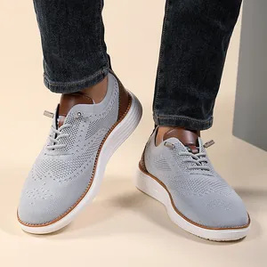 Detail of light grey knit loafers with brown leather accents and lace-up toggle closure