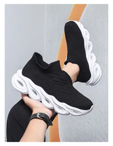 Close-up of black knitted slip-on shoe showing the textured mesh and hollow wavy sole