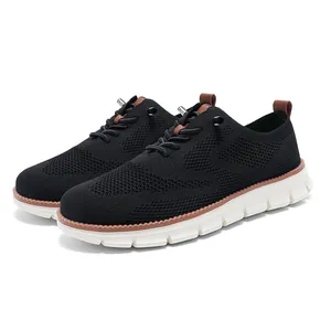 Detail of black breathable fly-knit men's casual sneaker with brown leather accents