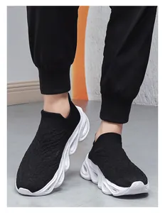 Close-up of black breathable knit upper and wavy white lightweight thick sole
