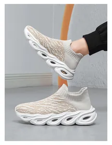 Detail view of breathable knitted upper and wavy platform sole on slip-on shoes