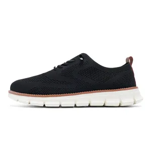 Detail of black knit walking shoe showing breathable mesh texture and brown heel pull tab