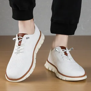Detail of white flyknit loafers with brown leather trim and elastic laces