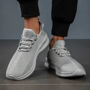 Macro shot of breathable mesh texture and non-slip wavy sole on gray sports sneakers