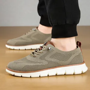 Detail of khaki knit sneakers with breathable texture, brown leather accents and EVA sole