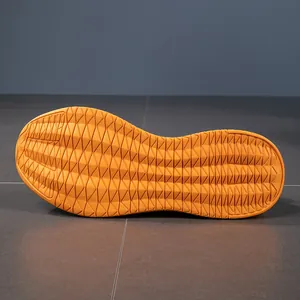 Detail of orange anti-slip rubber sole with dense geometric tread for grip and safety
