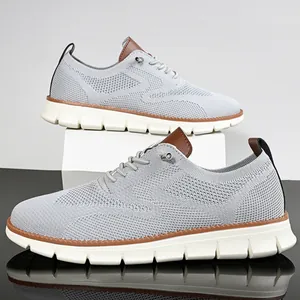 Detail of grey knitted loafers with brown leather accents and anti-slip white rubber sole