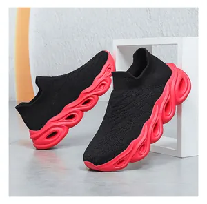 Detail view of breathable black knit upper and red shock-absorbing hollow wavy sole