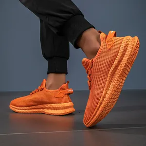 Detail view of bright orange breathable mesh running shoe with thick non-slip textured sole