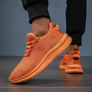 Men's breathable bright orange knit running sneakers with thick geometric soles