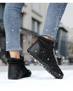 Detail of waterproof black winter snow boots with quilted fabric and anti-slip rubber soles