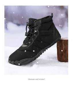 Waterproof black winter snow boot on snowy wood post with quilted fabric and toggle laces