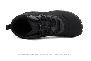 Close-up of black waterproof snow boots featuring a quick-lace drawstring system and wide toe box
