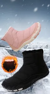 Close-up of waterproof mid-top snow boots featuring thick fleece lining and anti-slip rubber soles