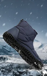 Detail showing non-slip rubber outsole and warm fleece lining on blue winter snow boots