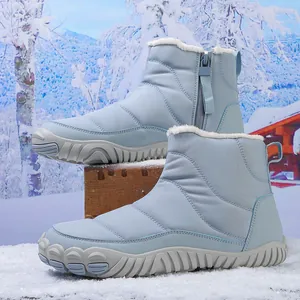 Close-up of light blue waterproof snow boots with thick faux fur lining and anti-slip sole