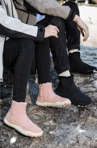Detail showing waterproof snow boots with warm plush lining and side zipper closure