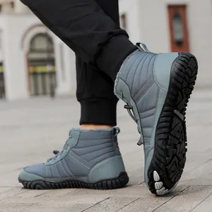 Close-up of gray high-top waterproof winter boots with warm fur lining and non-slip rubber sole