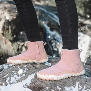 Pink high-top snow boot with quilted texture, warm lining, and non-slip sole in snow