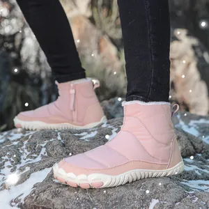 Detail view of pink waterproof snow boots featuring side zipper and thick anti-slip rubber sole