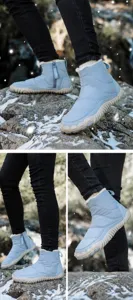 Detail showing thick white faux fur lining and side zipper of waterproof snow boots