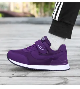 Close-up of purple orthopaedic walking shoe with velcro strap and non-slip white sole
