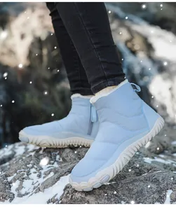 Close-up of quilted waterproof snow boots with plush lining and anti-slip thick sole