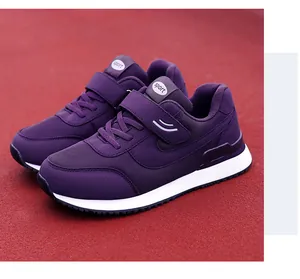 Purple mesh walking shoes on running track showing velcro strap and cushioned sole