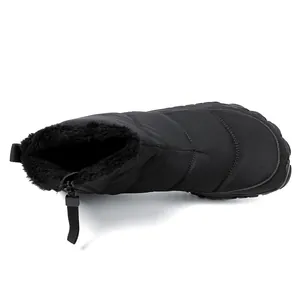 Detail of waterproof quilted snow boot with warm black faux fur lining and side zipper closure